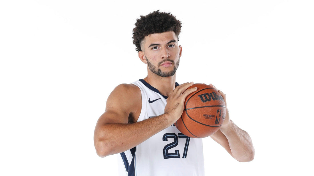Cameron Boozer holding a basketball in his white Memphis Grizzlies No. 27 jersey at 2026 media day