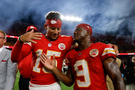 Patrick Mahomes and Kenneth Walker III celebrating together after a Chiefs victory in 2026