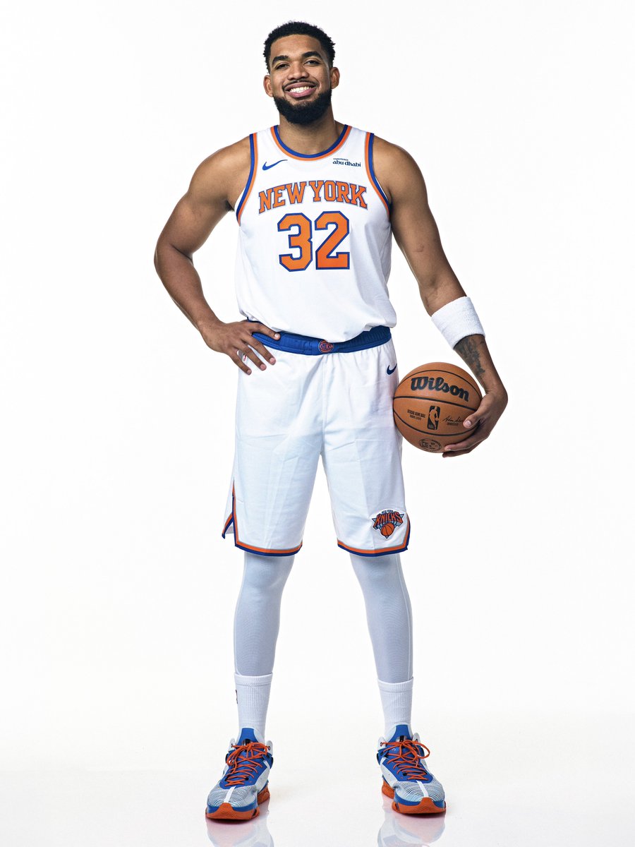Karl-Anthony Towns in New York Knicks white number 32 uniform holding a basketball