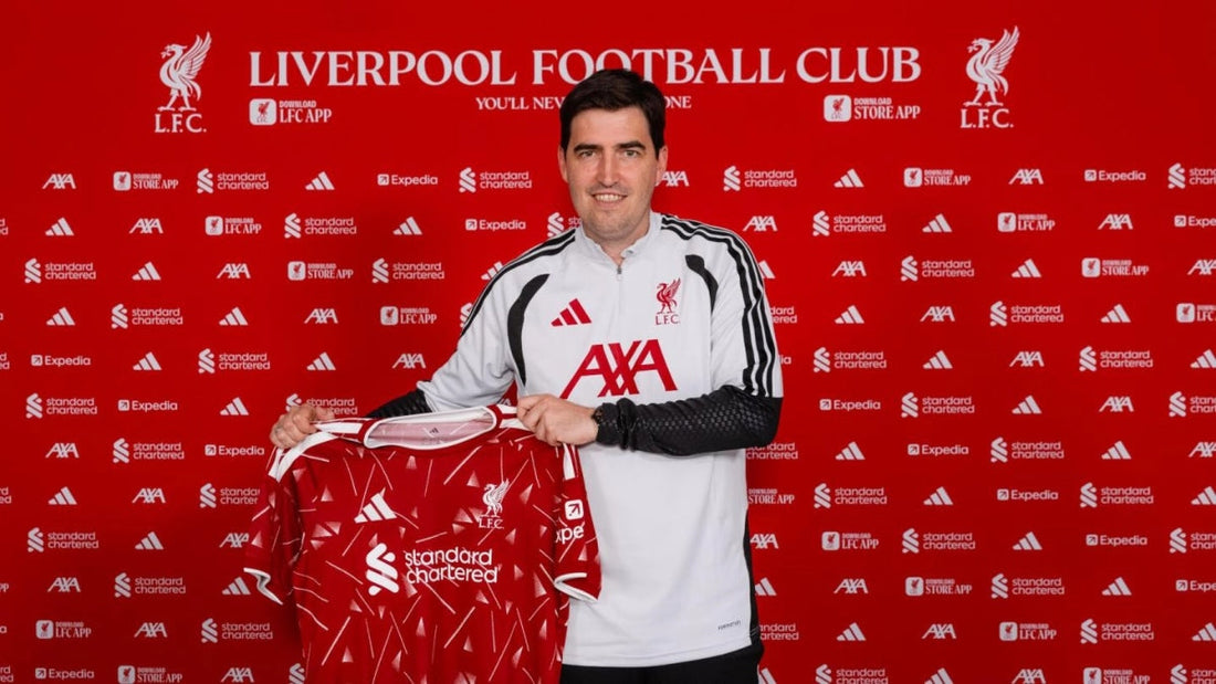 Andoni Iraola holding the Liverpool home shirt after becoming head coach in 2026