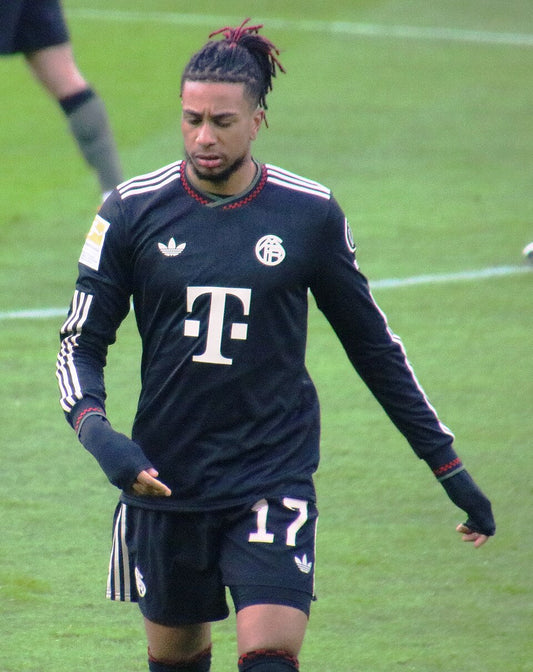Michael Olise in Bayern Munich's black kit during a January 2026 match