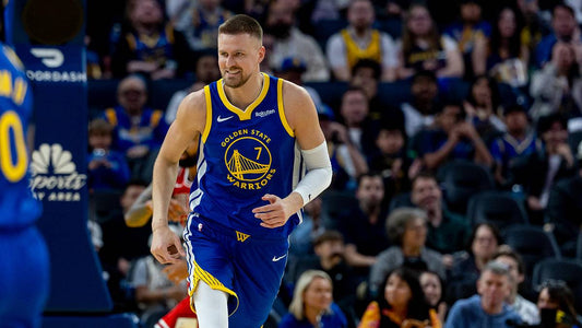 Kristaps Porziņģis in Golden State's blue and gold No. 7 jersey during a 2026 game
