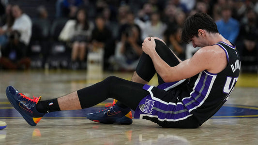 Maxime Raynaud holds his right knee during Sacramento's October 10 preseason game against Golden State