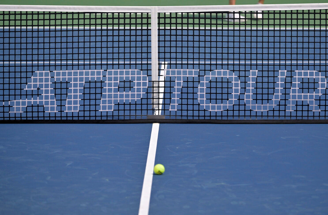 ATP Tour tennis net on a blue hard court