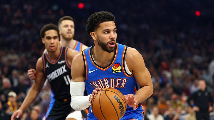 Ajay Mitchell handling the ball in Oklahoma City Thunder uniform against Phoenix in 2026