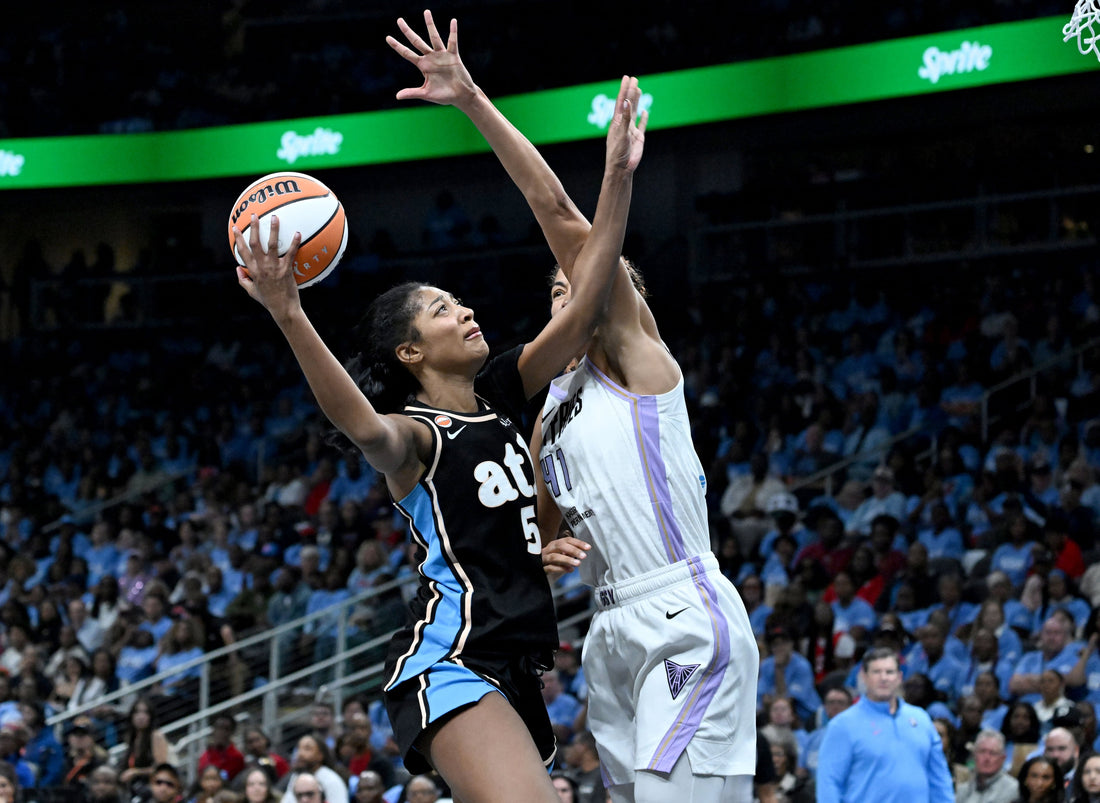 Angel Reese attacks the basket against Kiah Stokes in the 2026 WNBA Finals