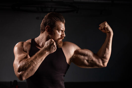 Olivier Richters flexing his massive bodybuilding physique in a dark gym