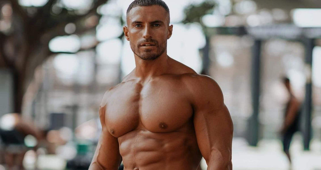 Mike Thurston standing shirtless with muscular chest, shoulders, arms and visible abdominal definition