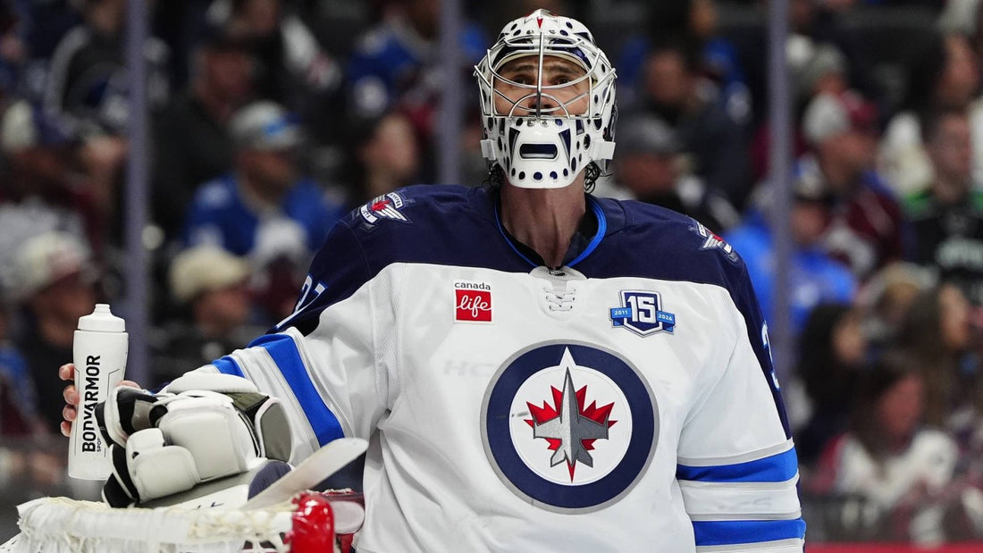 Connor Hellebuyck in Winnipeg Jets white jersey during the 2025-26 season