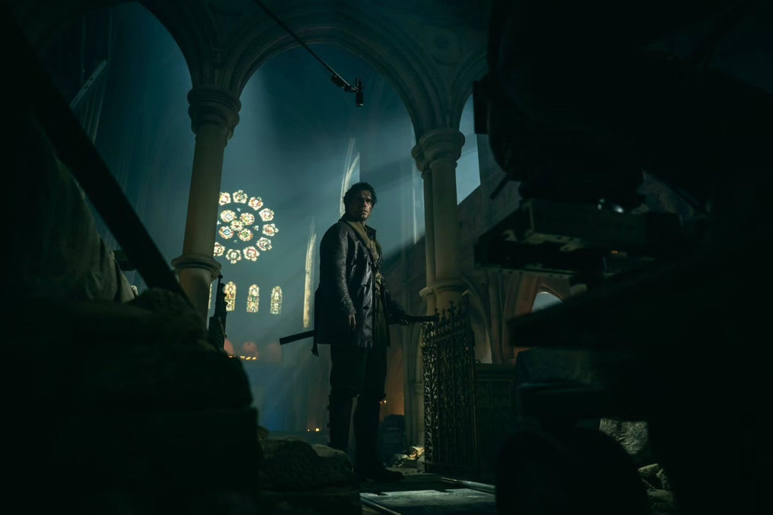 Henry Cavill as Connor MacLeod wearing a long dark coat among glowing red lanterns in Highlander