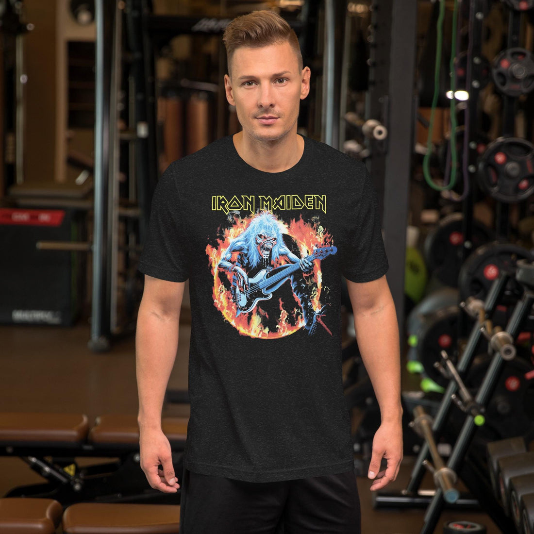 Gym-goer in a black Iron Maiden graphic T-shirt standing between weight machines