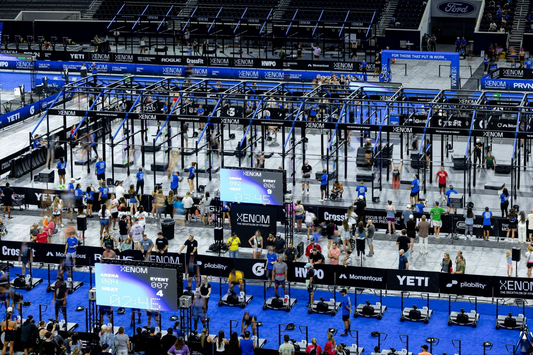 Wide view of athletes competing beneath XENOM rigs at the Dallas fitness decathlon