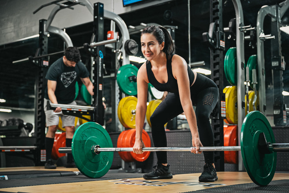 An athlete preparing a barbell deadlift during strength training