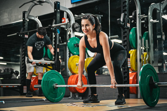An athlete preparing a barbell deadlift during strength training