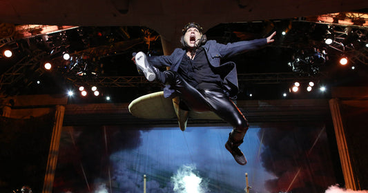 Bruce Dickinson leaping in midair during an Iron Maiden concert