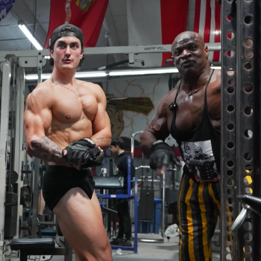 Jesse James West and Ronnie Coleman posing together in a bodybuilding gym