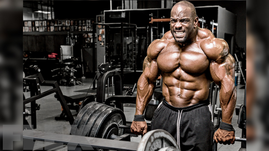 Johnnie Jackson performing a heavy barbell shrug with visibly developed trapezius muscles