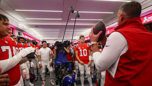 Mike Vrabel and Drake Maye celebrate in the Patriots locker room after the October 11 Raiders win