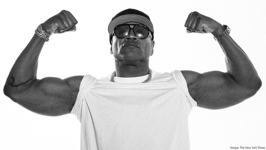 LL Cool J flexing his muscular arms in a black-and-white promotional portrait