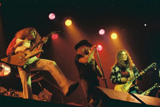 Classic Lynyrd Skynyrd live performance with wide stances and high-energy Southern-rock stage movement