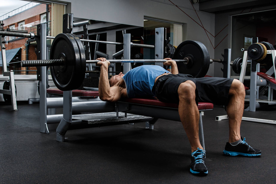 Athlete bench pressing during a high-volume muscle-building workout