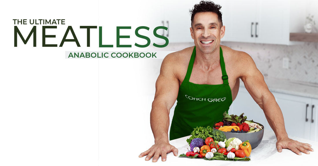 Greg Doucette in a green apron standing behind a bowl of fresh vegetables in a kitchen