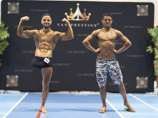 Two muscular competitors posing during a natural bodybuilding event