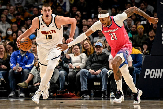Nikola Jokić dribbling in a white Denver Nuggets jersey against the Phoenix Suns in March 2026