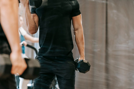 Athlete training with a barbell in a gym during a focused strength workout