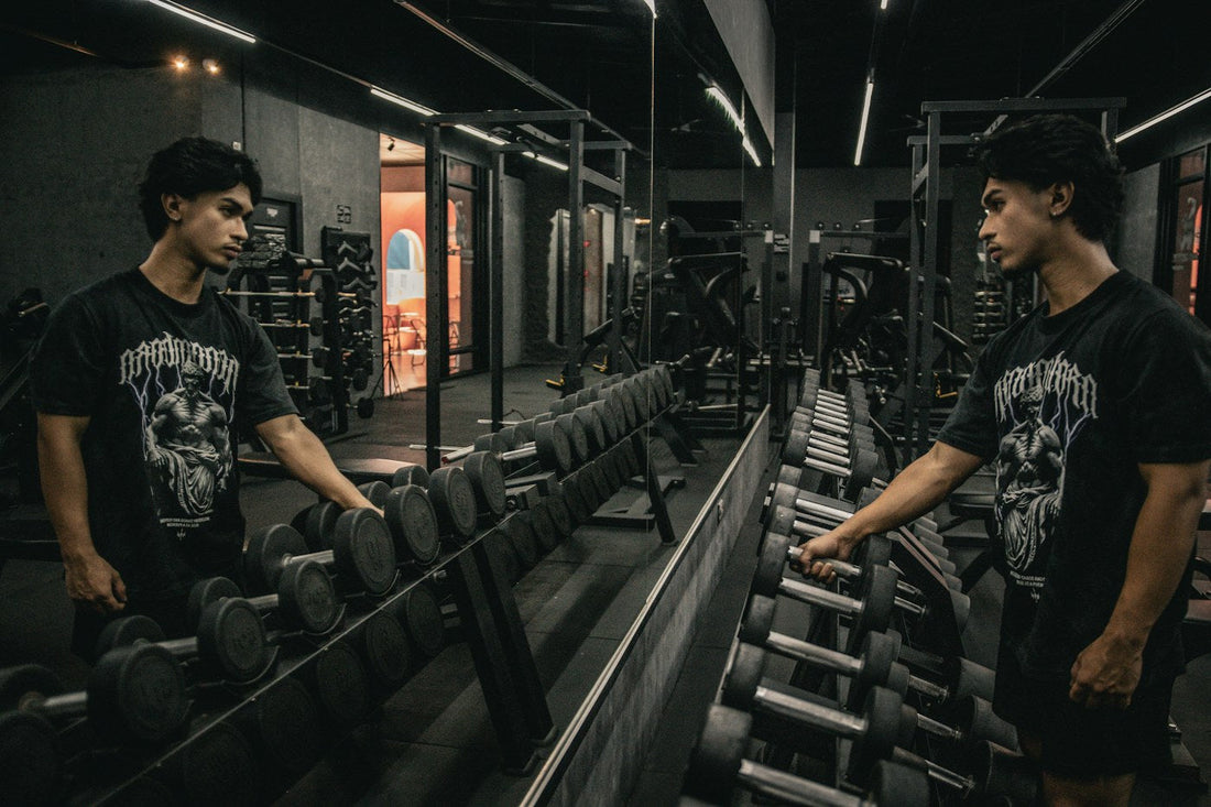 An athlete selecting a dumbbell from a rack in a modern weight room