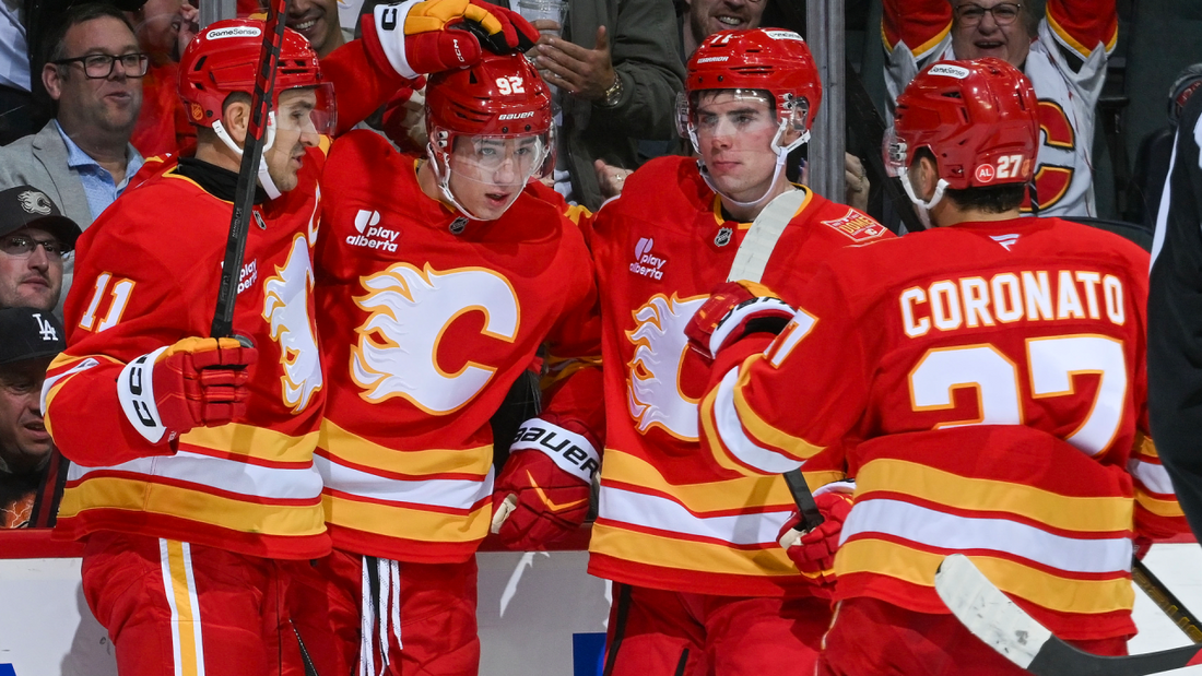 Calgary Flames players celebrating during the October 18, 2026 game against Carolina
