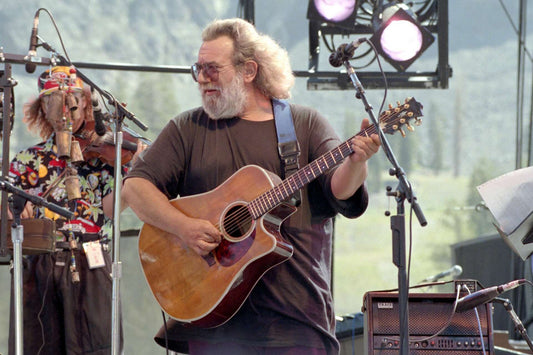 Jerry Garcia playing acoustic guitar during a mellow Grateful Dead performance