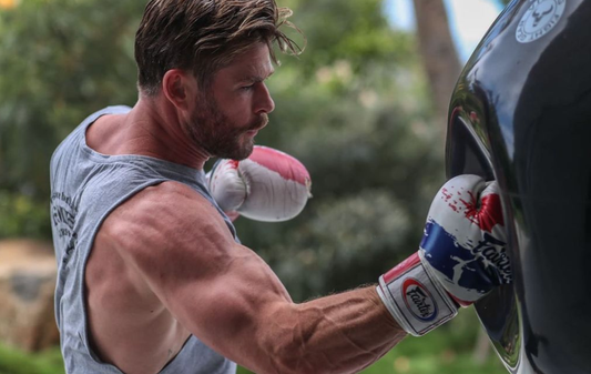 Chris Hemsworth in boxing gloves practicing punches during an earlier workout; illustrative archival training photograph