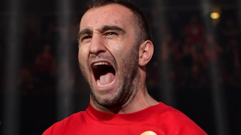 Murat Gassiev in red training gear in a 2026 heavyweight boxing portrait
