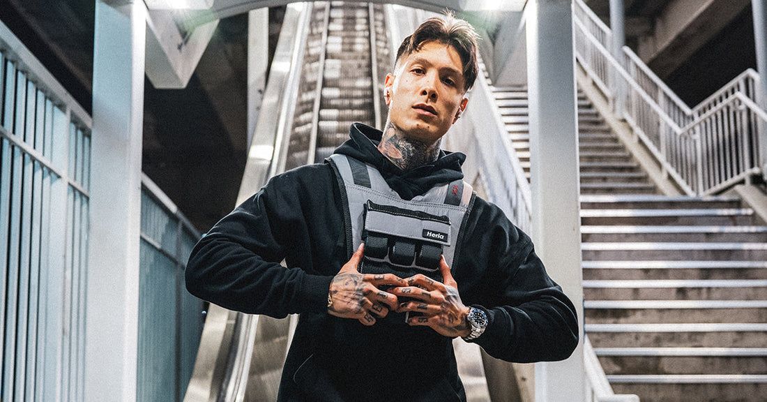 Chris Heria wearing a weighted training vest in an industrial stairwell