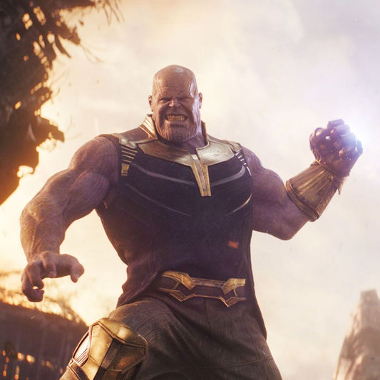 Thanos, the muscular Mad Titan, standing with his Infinity Gauntlet amid a battlefield