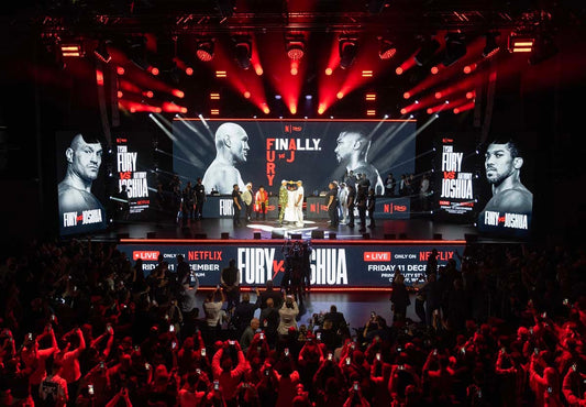Tyson Fury and Anthony Joshua face off on the wide Netflix press-conference stage in London in September 2026