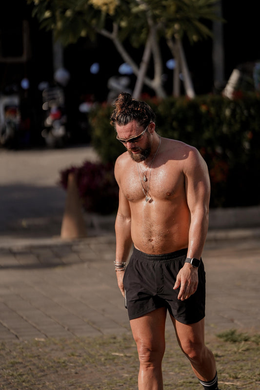 Fit man walking outdoors during a high-step fat-loss routine