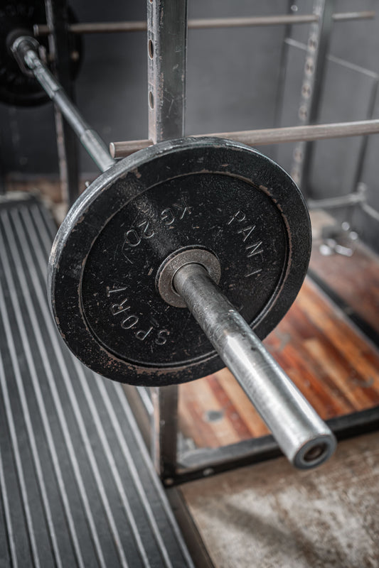 Loaded barbell on a rack in a modern gym
