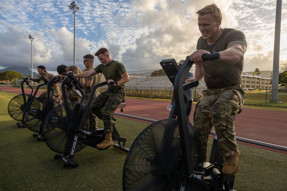 Athlete pushing through an assault bike workout