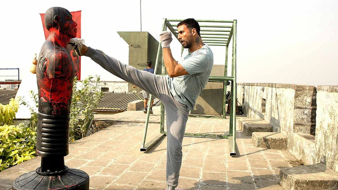 Akshay Kumar performing a high kick during martial arts training