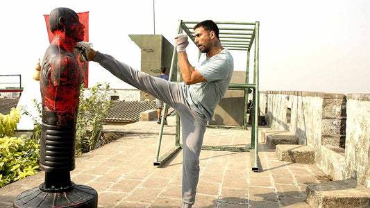 Akshay Kumar performing a high kick during martial arts training