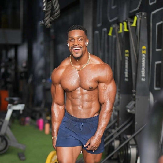 Ashton Hall smiling in a gym