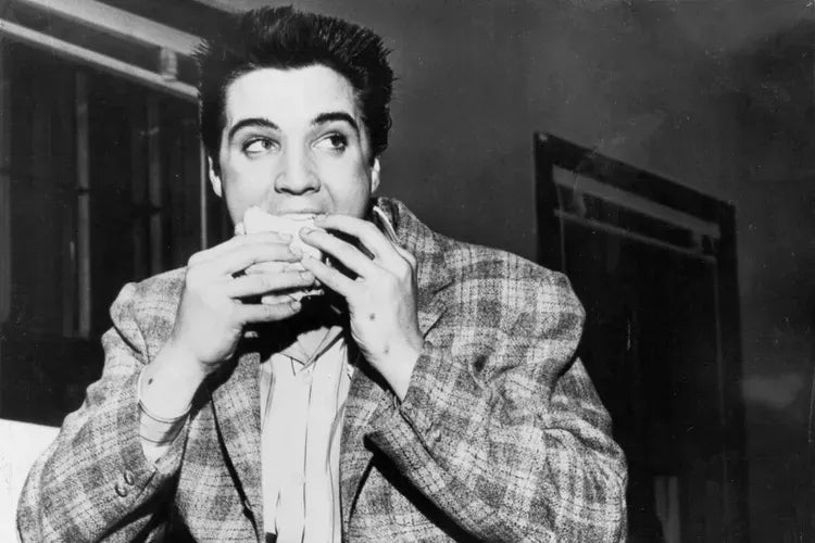 Elvis Presley eating a sandwich in 1958