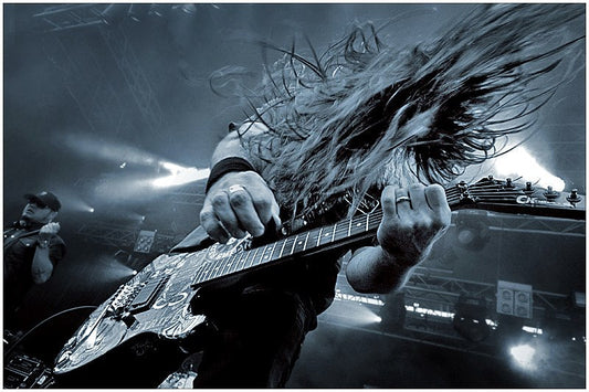 Metal guitarist shredding during a fast live performance