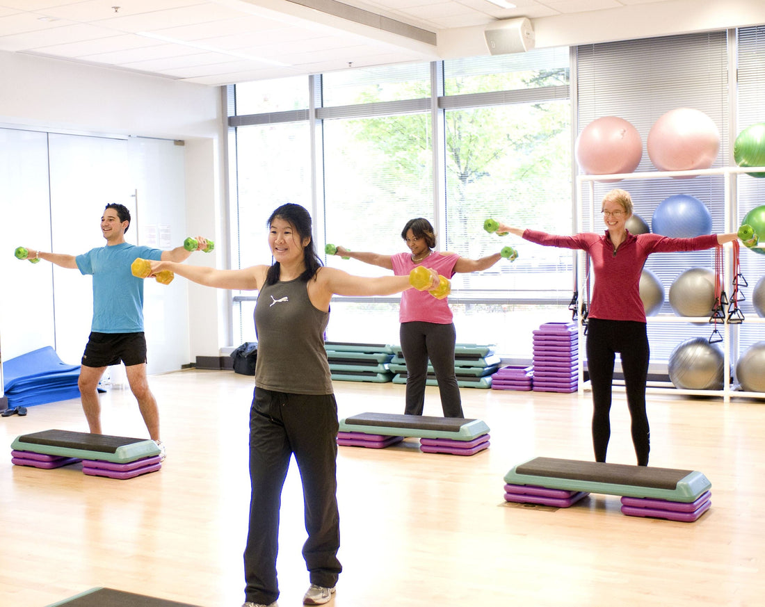Group fitness class training with dumbbells