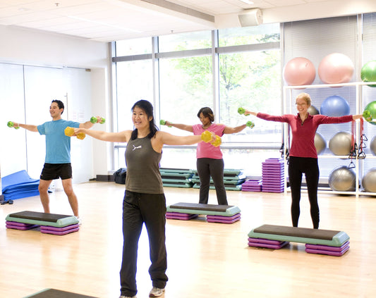 Group fitness class training with dumbbells