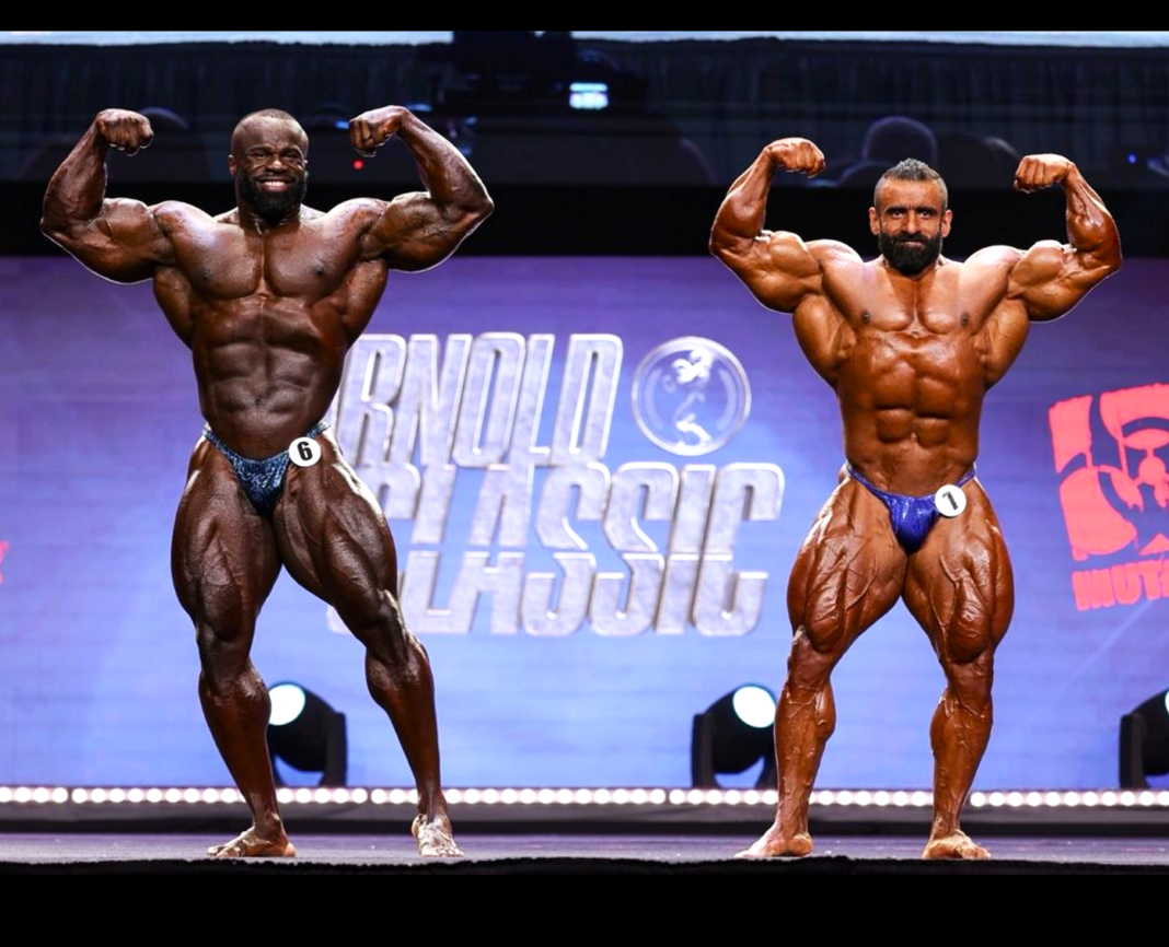 Hadi Choopan and Samson Dauda in a front double biceps comparison at the Arnold Classic