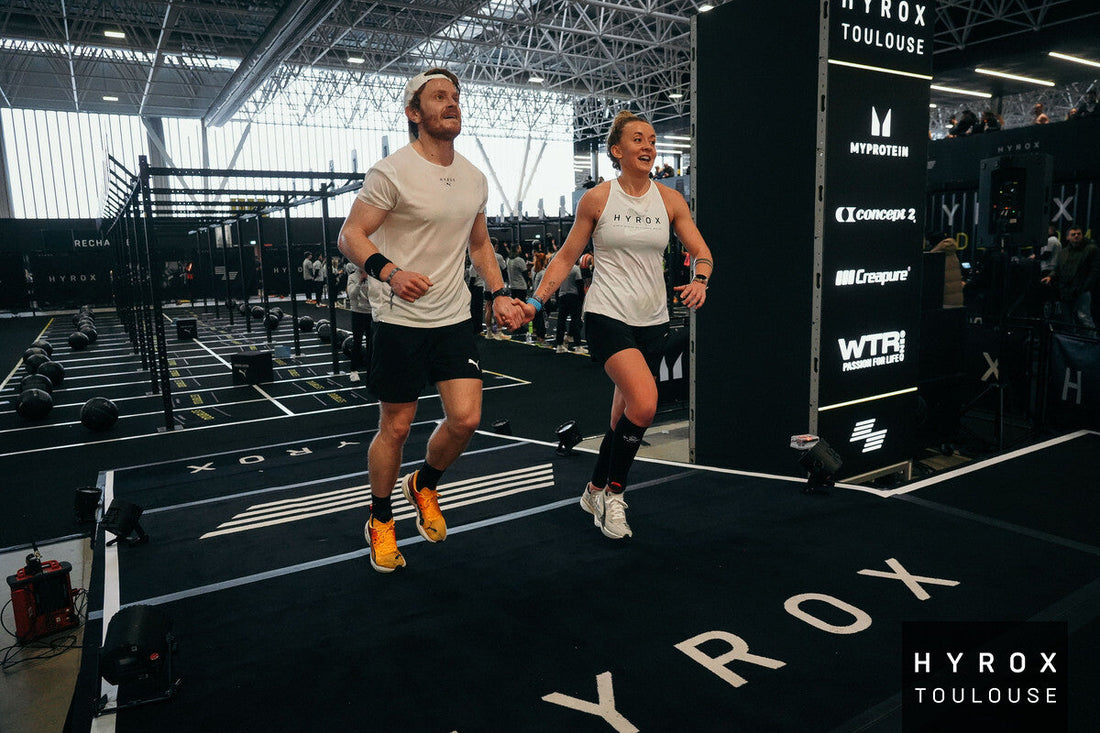 HYROX athletes running together during a hybrid fitness race