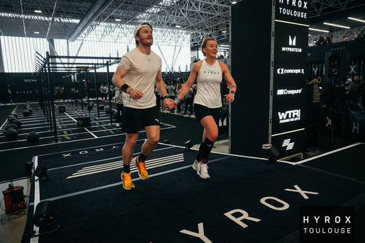 HYROX athletes running together during a hybrid fitness race